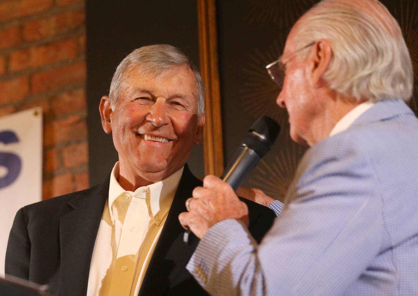 Ken Jenkins smiles while being interviewed by emcee Lanny Slevin during the Illinois Valley Sports Hall of Fame awards banquet on Thursday, June 6, 2024 at the Auditorium Ballroom in La Salle.