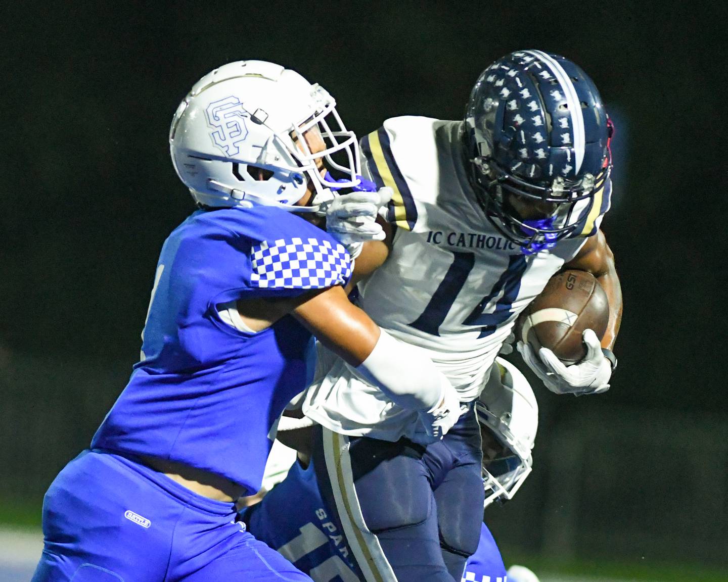 IC Catholic Prep KJ Parker (14) gains some yards before getting wrapped up by St. Francis Corin Greenwell, left, during the second quarter on Friday Sep. 29, 2023, held at St. Francis in Wheaton.
