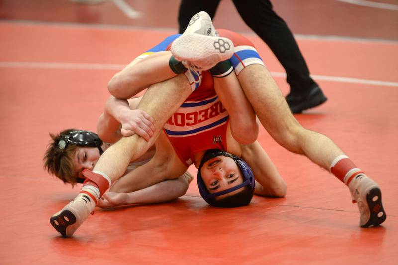 Oregon’s Josiah Perez (bottom) battles Johnsburg’s Chase Vogel during a 113-pound match at the 1A Oregon Sectional on Saturday, Feb. 15, 2025.