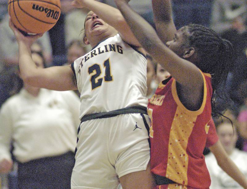 Sterling's Jaelynn James goes up against a Rock Island player.Western Big 6 conference champions Sterling hosted Rock Island in girls basketball. The action took place Thursday, February 13, 2025 at Musgrove Fieldhouse at SHS.
