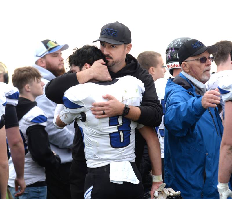 Eastland-Pearl City coach Jared McNutt gives senior Tanner Stern a hug after EPC fell  to Taylor-Rockridge 22-8 in the 2A state football playoff's first round on Saturday, Nov. 2, 2024 at Eddington.