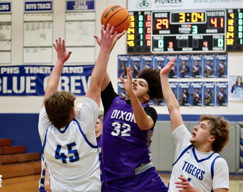 Dixon's Darius Harrington shoots over Princeton's Luke Smith (45) and Jayden Fulkerson Monday night at Prouty Gym. He scored 36 points to lead the Dukes to a 61-50 win.