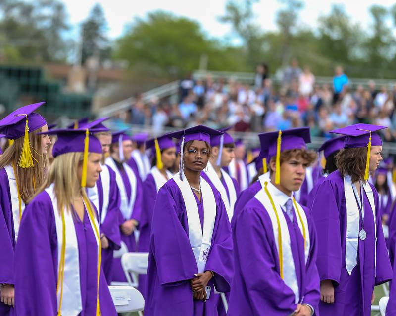 Graduands stand during the Downers Grove North graduation ceremony at the school on Sunday, May 22, 2022