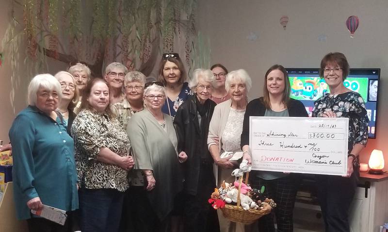 Members of the Oregon Woman’s Club present a check and a basket of toys to Jessica Cash, executive director of Shining Star Children’s Advocacy Center. Pictured left to right in the front row are: Nancy Bartels, Jan Larson, Sharon Lung, Fran Strouse, Barb Semsel, Jessica Cash, executive director, Shining Star, and Jan Steward, OWC president; Second row: Rosemary Underwood, Linda Arnold; Back Row: Audrey Taylor, Sandie Chasm, Johanna Hahne, Joyce Dixon.