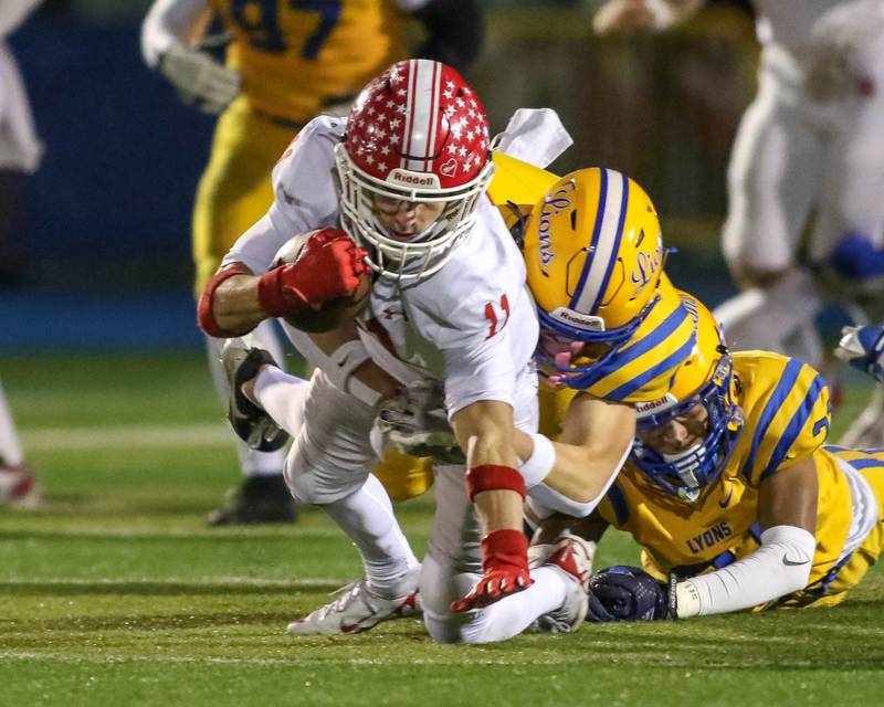 Naperville Central's Vincent Bern (11) dives for yards after a short catch during Class 8A quarterfinal football game between Naperville Central at Lyons on Friday, Nov 15, 2024  in Western Springs.