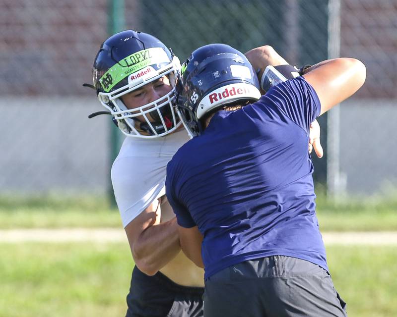The defensive line goes through rushing drills at Nazareth Academy Football Practice, Monday, Aug 11, 2025  in La Grange.