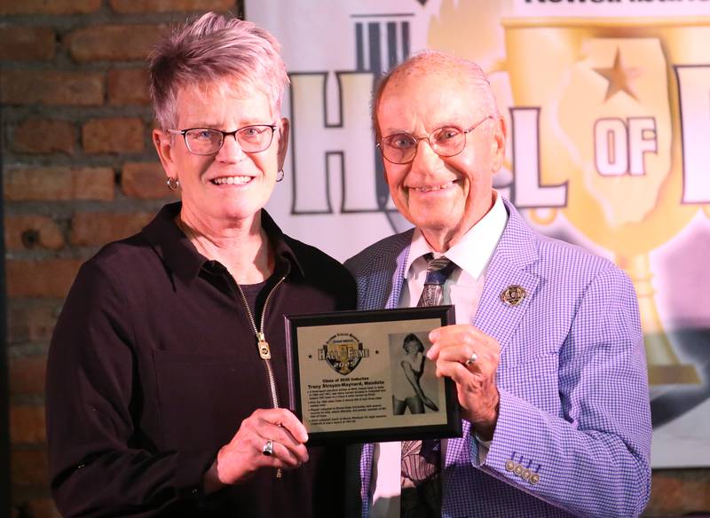 Mendota alumna Tracy Stroyan-Maynard holds her award with emcee Lanny Slevin during the 2025 Shaw Media Illinois Valley Sports Hall of Fame at the Auditorium Ballroom in La Salle.