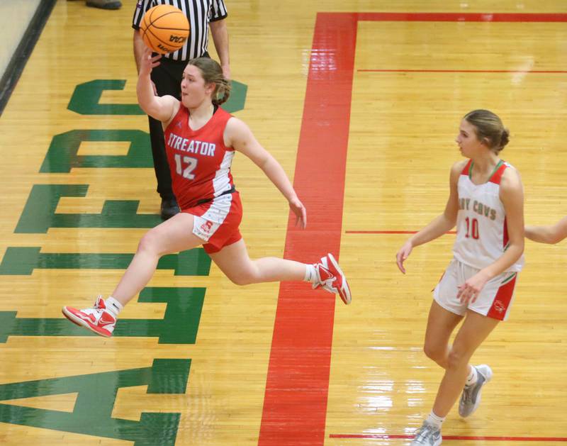 Streator's Leah Krohe saves the ball from going out of bounce as L-P's Kelsey Frederick watches on Tuesday, Jan. 28, 2025 in Sellett Gymnasium at L-P High School.