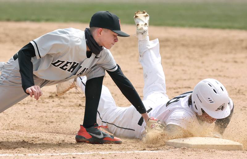 DeKalb's Jackson Kees tags Kaneland's Collin Miller as he slides safely back into first on a pickoff attempt during their game Friday, April 15, 2022, at Kaneland High School in Maple Park.