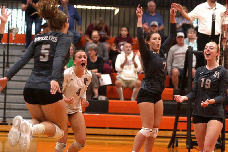 Prairie Ridge’s Wolves get excited during their three-set win in varsity volleyball at Crystal Lake Central Thursday night.