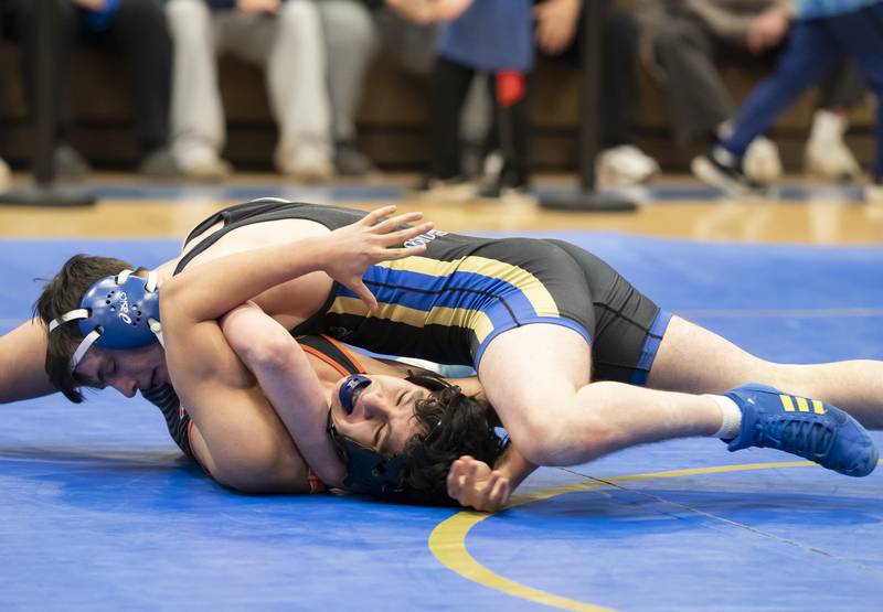 Crystal Lake Central's Abraham Palomino wrestles with Wheeling's Austin Berger in the 144 pound bout during the Class 2A Dual Team wrestling Sectional on Tuesday, February 25, 2025 at Wheeling High School. Ryan Rayburn for Shaw Local