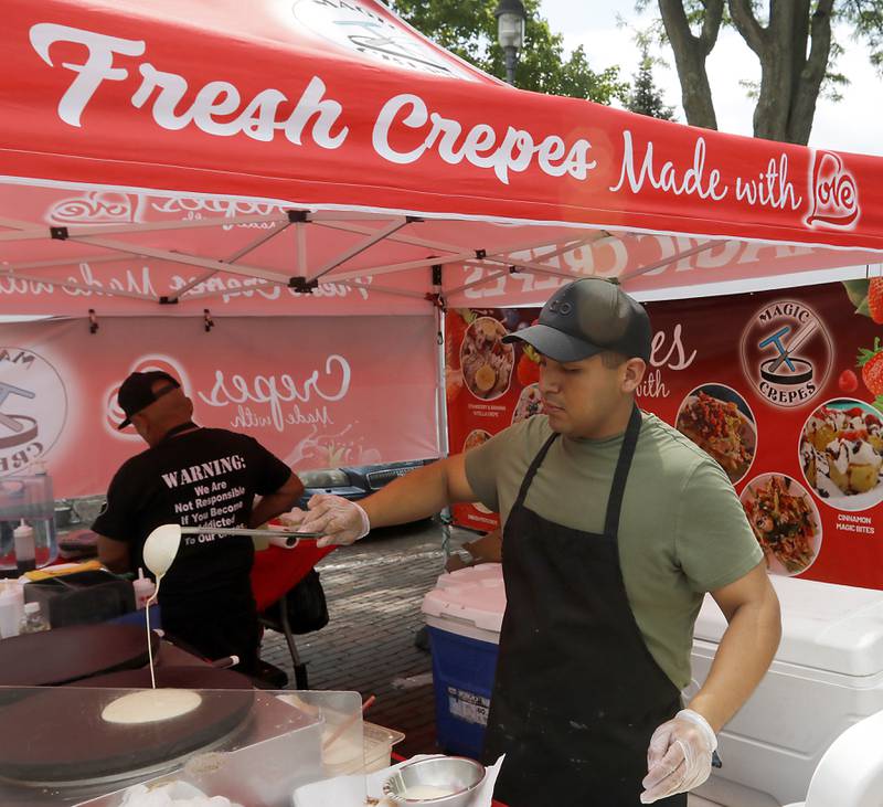 Cris Lopez of Magic Crepes makes a crepe for a customer at the Tuesday Woodstock Farmer's Market on June 24, 2025, around the Historic Woodstock Square.