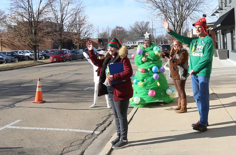 Volunteers wave to motorists while collecting food and monetary donations for the Ottawa Community Food Basket during the 14th annual Freezin' For a Reason' event on Friday, Dec. 2, 2022 in Ottawa.