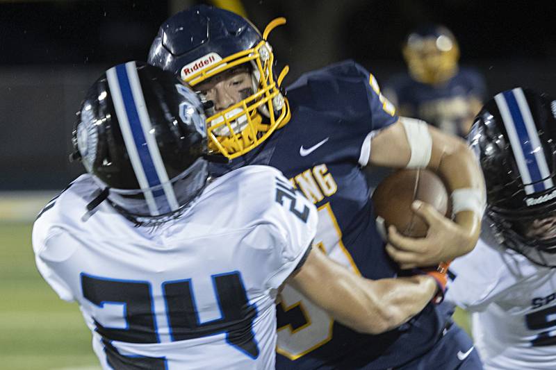 Sterling’s Gage Tate is wrapped up by St. Francis’ Tanner Glock Friday, Sept. 1, 2023 at Sterling High School.