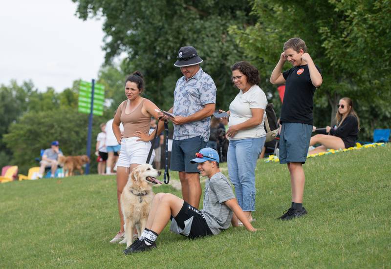 The Lemke family and their dog Babe attend the Kane County Cougar's "Bark in the Park" event at Northwestern Medicine Field on Tuesday, July 26, 2022.