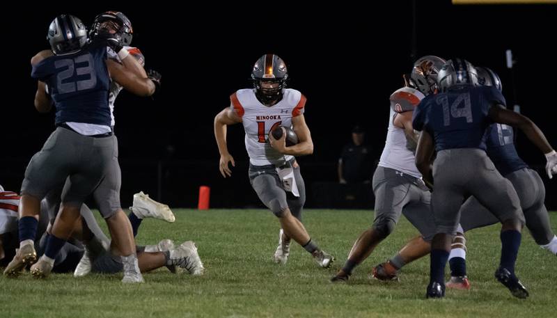 Minooka’s Ethan Murphy (16) carries the ball on a keeper against Oswego East during a varsity football game at Oswego East High School in Oswego on Friday, Oct 1, 2021.