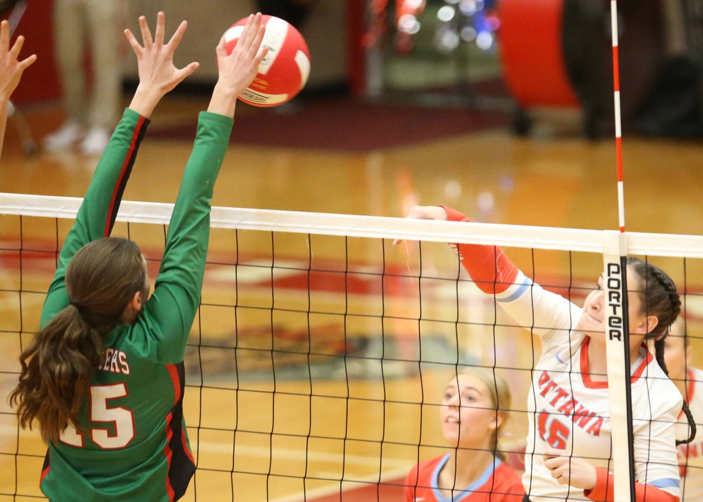 Ottawa's Mary Stisser's spike is blocked by L-P's Drew Depenbrock on Thursday, Oct. 17, 2024 in Kingman Gym at Ottawa High School.