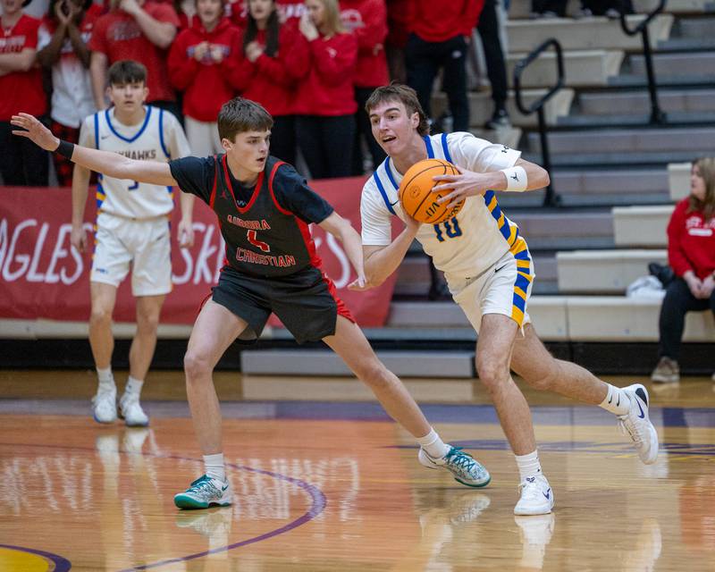 Ashton Stern (10) of Johnsburg looks to teammate to pass ball whilst being guarded by Aurora Christian's Joe DeCort (4) during the Class 2A Boys Sectional Basketball tournament game on Wednesday, March 4, 2026 at Mendota High School.