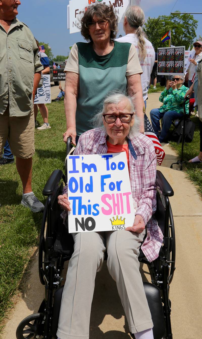 Editha Fetzer, assisted by her daughter, holds a sign at the No Kings Protest in Yorkville on Saturday, June 14, 2025.