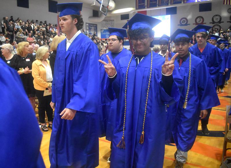 Bret Simon (left) and Christopher Rodas-Munoz walk with their fellow Genoa-Kingston graduating classmates Saturday, May 17, 2025, during graduation at the school.