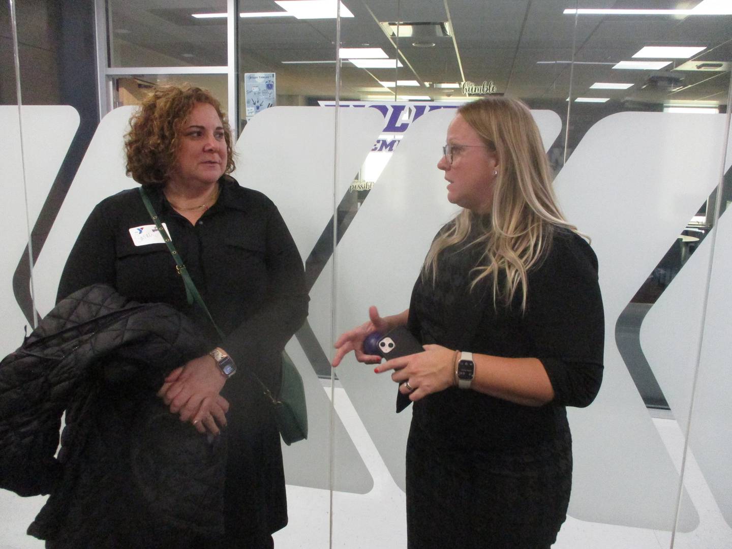 Katy Leclair, president and CEO of the Greater Joliet Area YMCA, (right) talks with Sarah Kinsella, community marketing and engagement manager with Old National Bank, in the new YMCA office at the Joliet Junior College Event Center on Feb. 6, 2025
