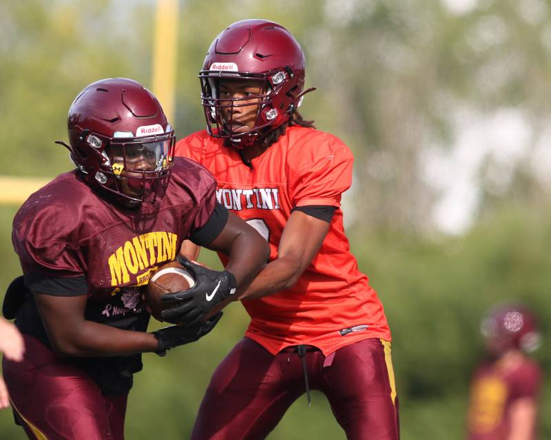 Izzy Abrams hands off to the running back at Montini High School football practice. Aug 22 2024.