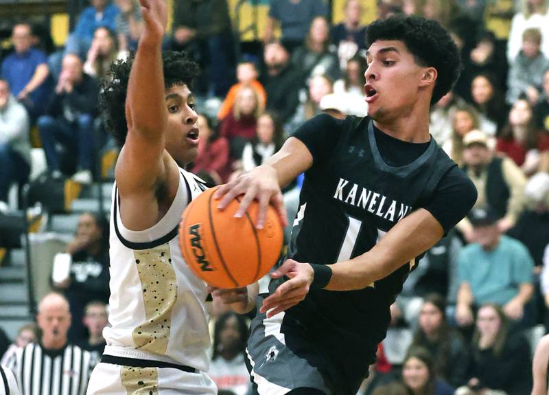 Kaneland's Evan Frieders passes the ball around Sycamore's Tyler Townsend during their game Friday, Jan. 9, 2025, at Sycamore High School.