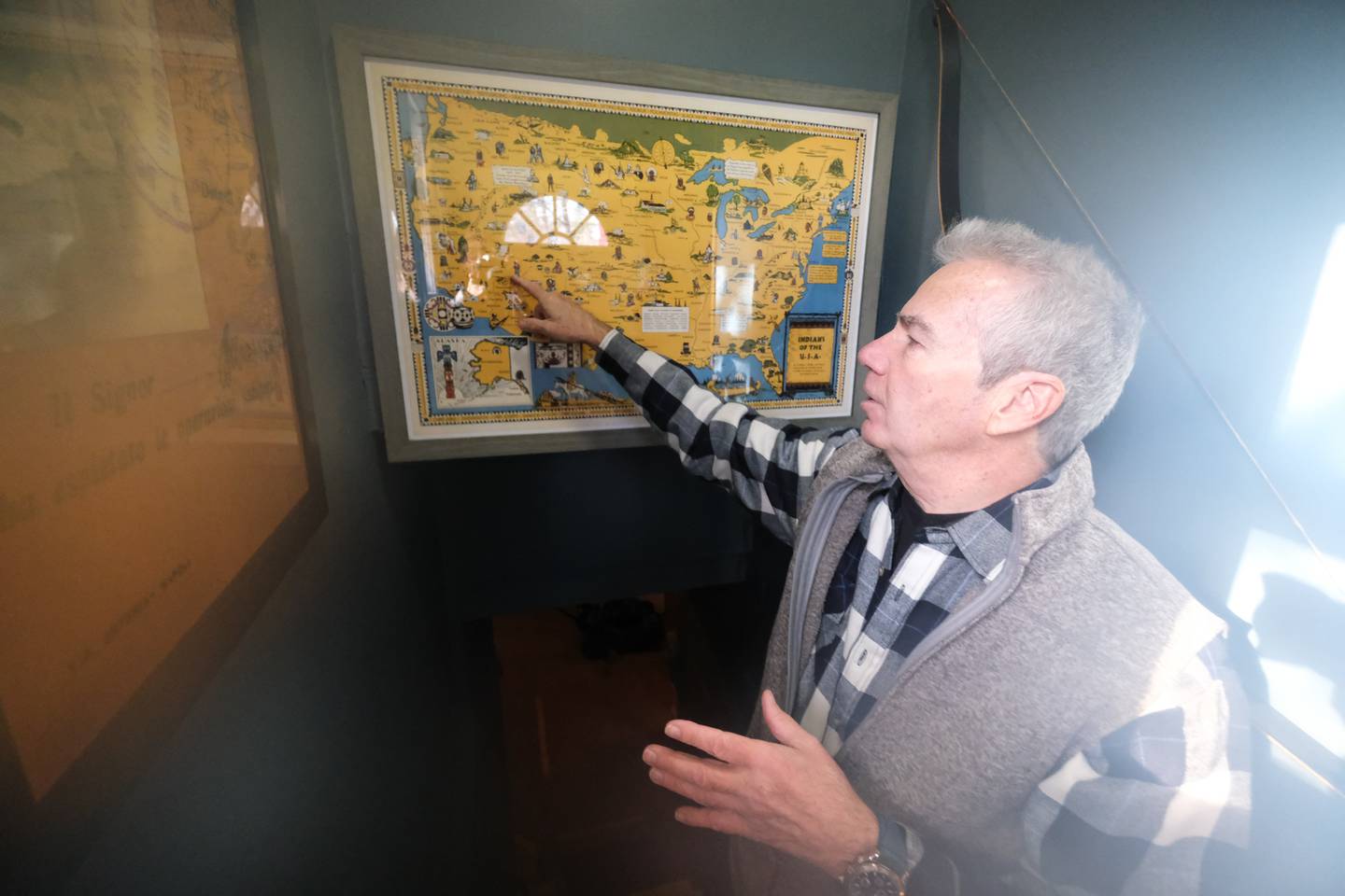 David Kump goes over a map gifted to him displaying Native American origins. David is on on a one-man mission to make people aware of the anniversary of the massacre at Wounded Knee and Native American history. Wednesday, Dec. 22, 2021 in Joliet.