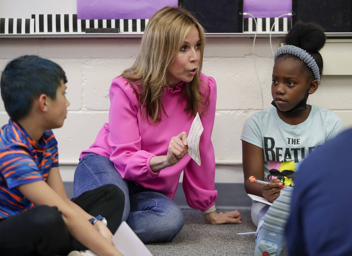 Christine Reynolds works with Jax DiGiacamo, left, and Londyn Lawson, right, during the Podcast Club at Henry Puffer Elementary School in Downers Grove on Thursday, March 24, 2022.
