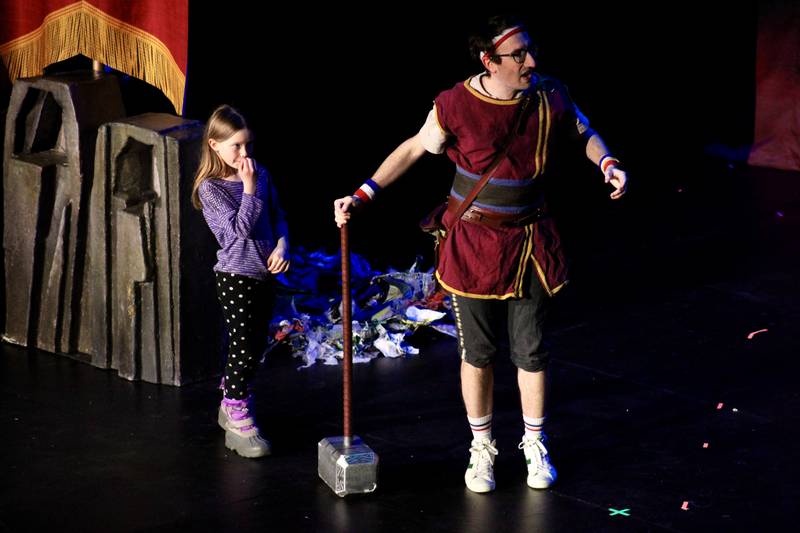 An audience member joins Dave the Hero Trainer as he contemplates using Thor's hammer as a means of getting a stone troll to give up its treasure during "Dragons and Mythical Beasts" that had two performances Saturday, Feb. 11, 2023, at Dixon Theatre.