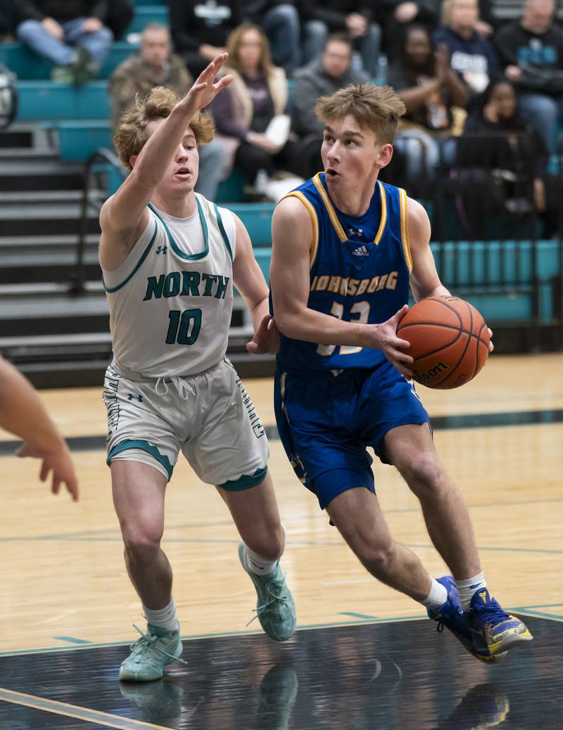 Johnsburg's JT Schmitt looks to shoot around Woodstock North defender Trevor Mark during their game on Wednesday, January 31, 2024 at Woodstock North High School. Ryan Rayburn for Shaw Local