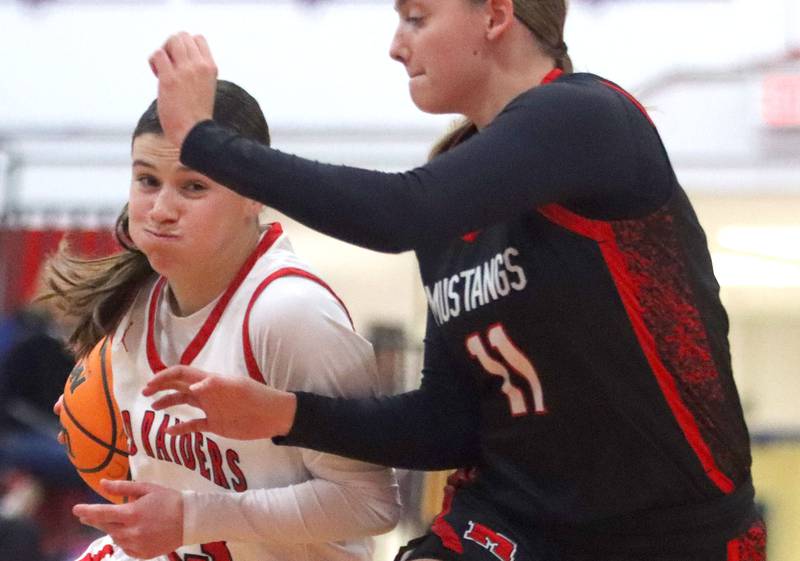 Huntley’s Aubrina Adamik, left, drives on Mundelein’s Casey Vyverman in varsity girls basketball Komaromy Classic tournament  action on Tuesday, Dec. 30, 2025, at Dundee-Crown High School in Carpentersville.