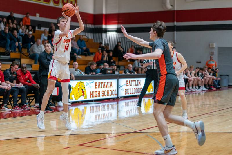 Batavia’s Jack Ambrose (14) shoots a three-pointer against St. Charles East during a basketball game at Batavia High School on Friday, Feb 10, 2023.