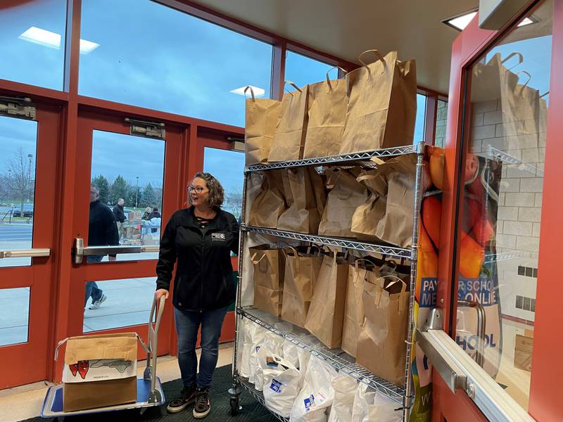 Sarah Oprzedek, vice president of operations and development at United Way of Will County, works the food and hygiene station at a Family Support Day in the fall of 2022. Family Support Days serve families who have lost their homes or experience economic hardships.
