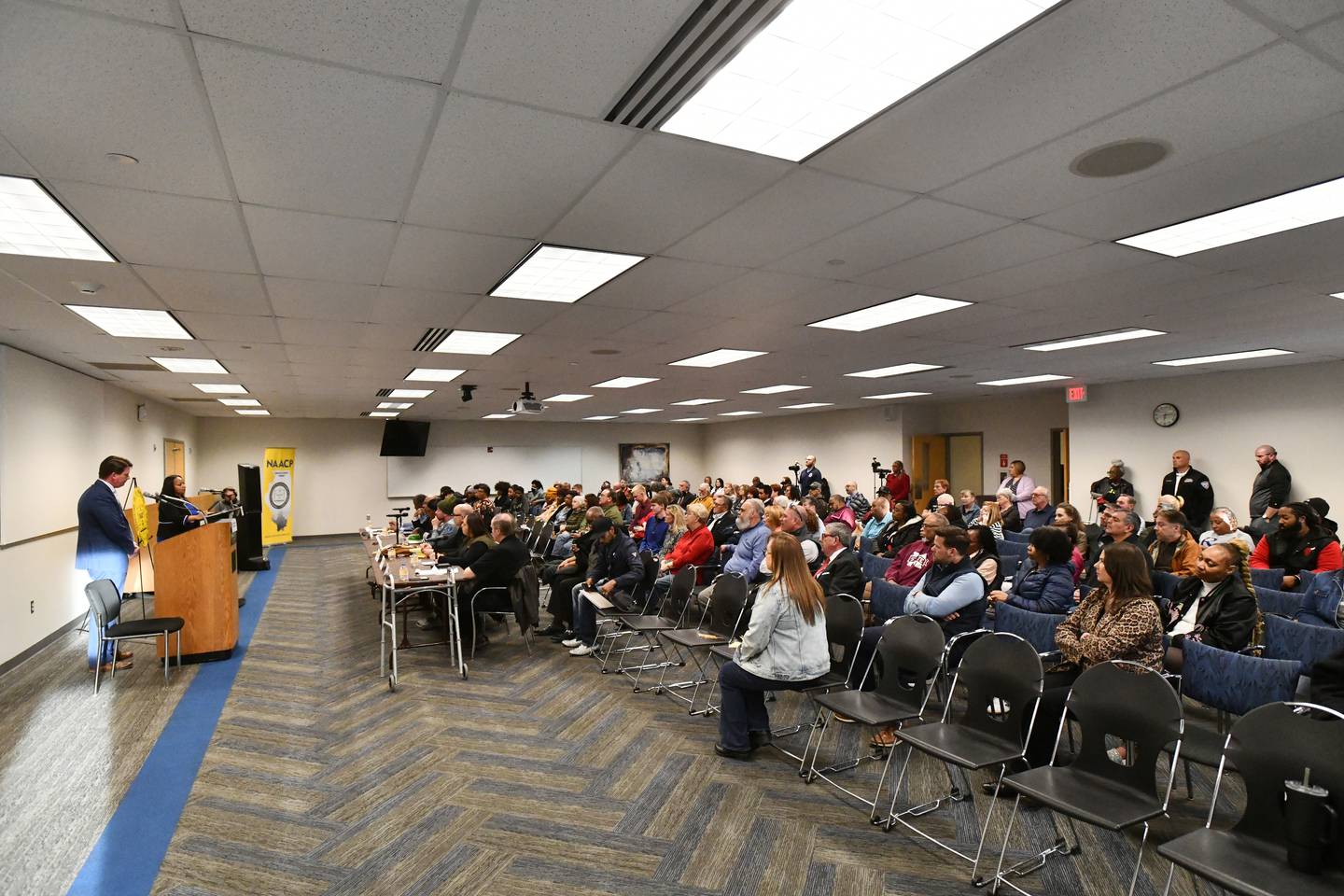 A crowd of about 100 people listen as Kankakee Mayor Chris Curtis, left, and Democratic mayoral candidate Genevra Walters answer questions during the Kankakee County NAACP Candidates Forum on Tuesday, March 11, 2025, at Kankakee Community College.