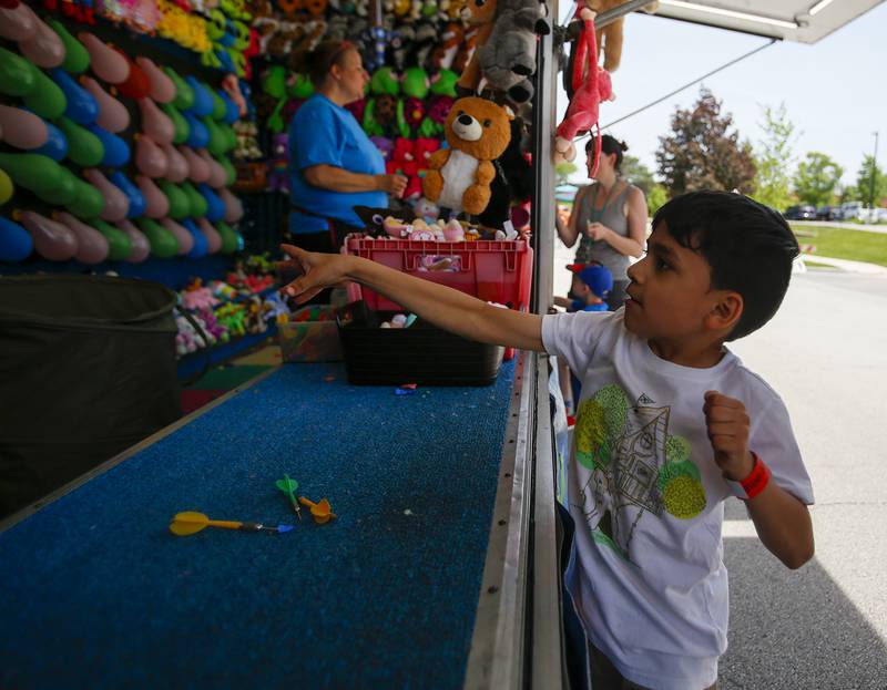 Xander Arcos, 7, of Cicero plays a carnival game during the Spring Fling in Westmont, Ill. on Sunday, May 29, 2022.