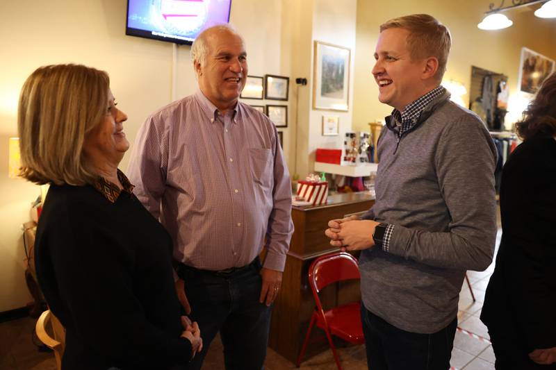 Tom Demmer, State Representative and candidate for State Treasurer, right talks with supporters Bob and Luanne Stewart at the GOP event at Its Amazing in Joliet on Monday.