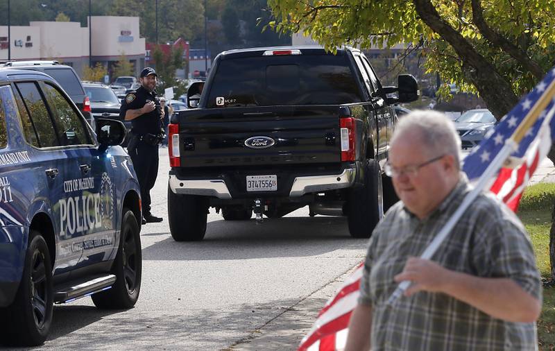 McHenry police officers conduit a traffic stop on a vehicle that created a large about of exhaust flumes during a "No Kings” protest rally on Saturday, Oct. 18, 2025, along Route 31 in McHenry. The protest drew thousands of protesters to the area to protest the policies of President Donald Trump.