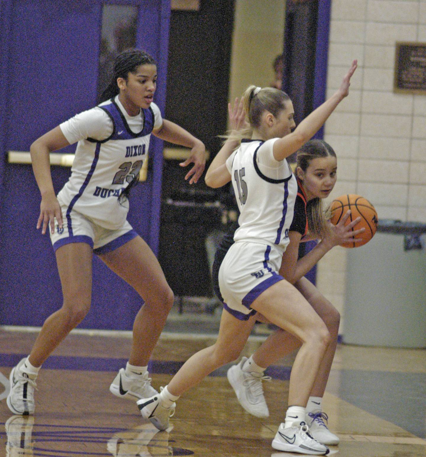 Dixon's Ahmyrie McGowan and Morgan Hargrave defend against a Byron player. The Dixon Duchesses hosted Byron in girls basketball Saturday, Jan. 25, 2025.