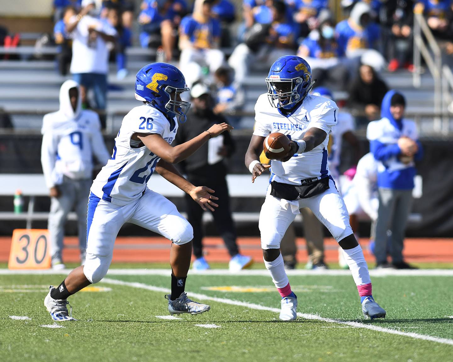 Joliet Central's Jonas Gregory hands the ball off the running back on Saturday, Oct.  16, 2021, at Joliet West High School in Joliet, IL. ( Dean Reid for Shawmedia.com )