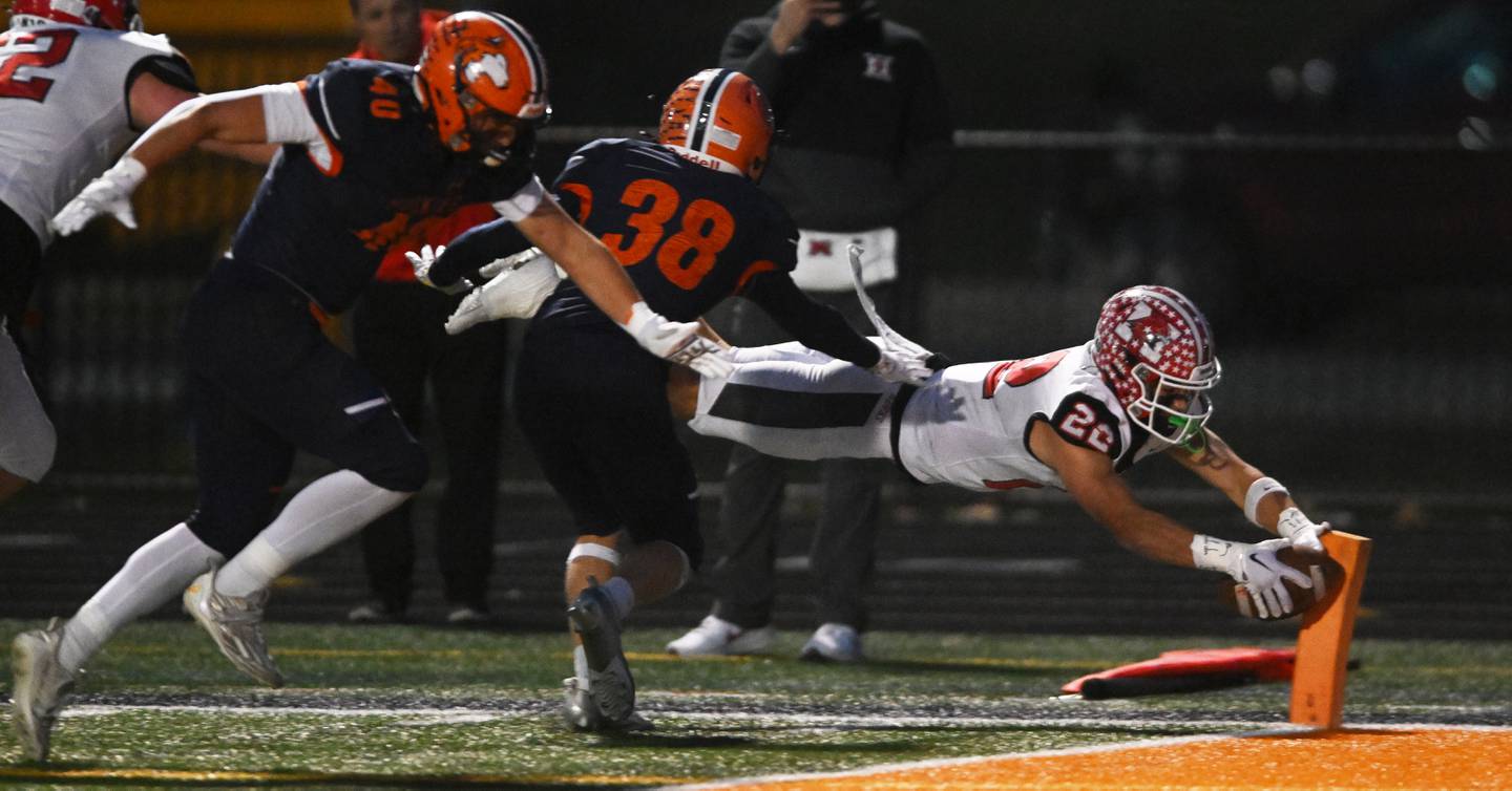Maine South’s Michael Dellumo dives into the end zone for a first-quarter touchdown against Naperville North during the Class 8A first-round playoff football game on Saturday, Nov. 2, 2024 in Naperville.