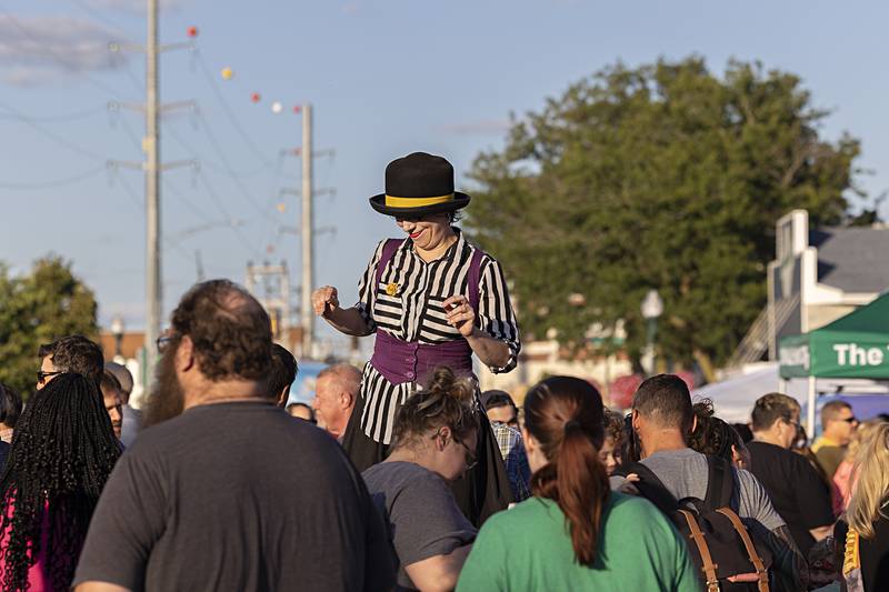 Wearing stilts, street performer Raquel Torre rises above the crowd Saturday, Aug. 10, 2024, during Dixon’s Venetian Night. Street performers, masks, music, food, magic and fireworks were all found at the riverside festival.