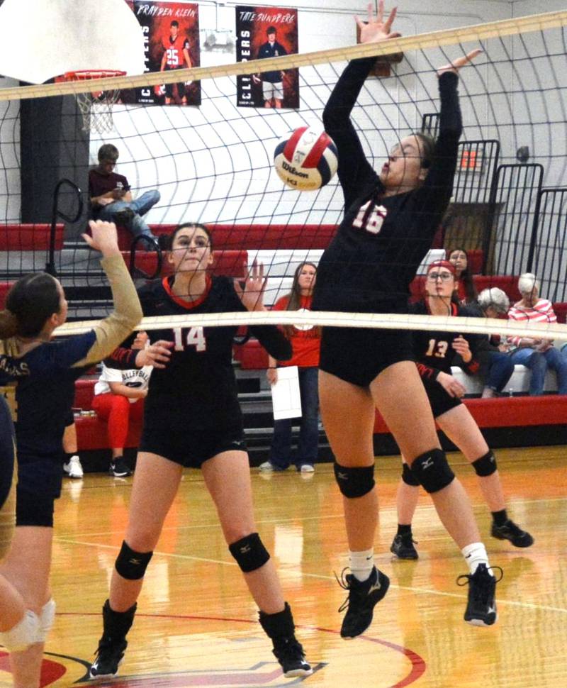 LaMoille's Claire Lovgren and Jena Monroe defend the net against Hiawatha Tuesday at Dean Madsen Gymnasium at LaMoille.