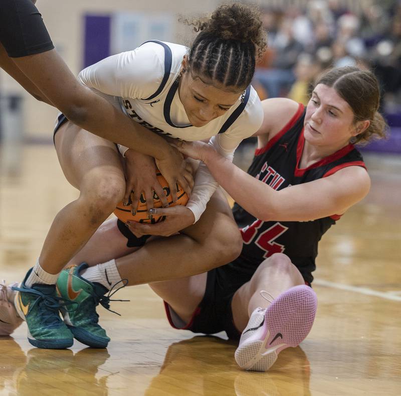 Sterling’s Delali Amankwa and Stillman Valley’s Brooke Jordal fight for a ball Friday, Dec. 27, 2024, during the Dixon Girls KSB Holiday Basketball Classic.