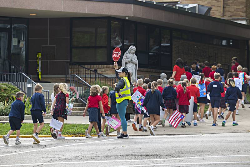 Students from St. Mary’s in Dixon return from their annual “Walk, Pray, Love-a-Thon” Friday, Sept. 22, 2023. After a performance by the school band, staff and students paraded down to the riverfront with signs spreading their love and praise.