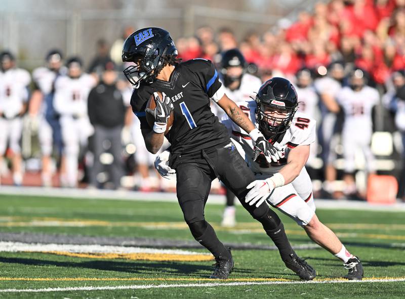 Lincoln-Way East's Stephon Gardner-gist (1)  tries to break away from Barrington's Brooks Howard (40)  during the IHSA class 8A semifinals playoff game on Saturday, Nov. 18, 2023, at Frankfort. (Dean Reid for Shaw Local News Network)