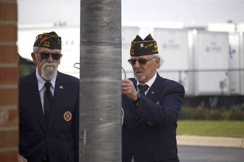 Stone City VFW Post 2199 members Mike Scovel (left) and Edward Chartrand, the latter of whom is a chaplain, work to raise the U.S. flag for Veterans Day at the VFW Post at 124 Stone City Drive, Joliet, on Tuesday, Nov. 11, 2025.