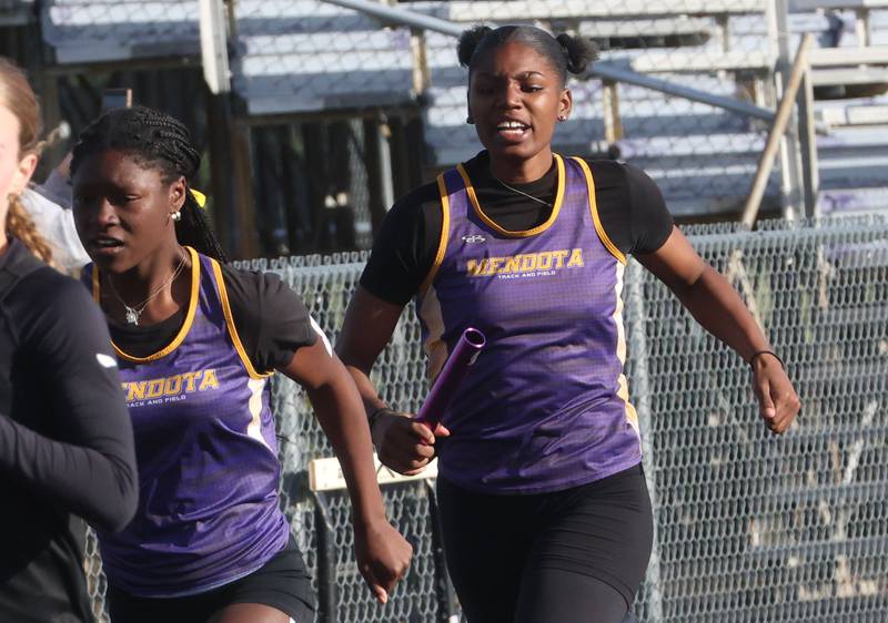 Mendota's Jeniah Francis gets the baton from Mariyah Elam in the 4x200 relay during the Class 2A Sectional track meet on Wednesday, May 13, 2026 in the Jeff Prusator Athletic Complex at Mendota High School.