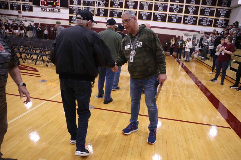 Micheal Zaworski greets each veteran as the proceed into the gymnasium at the Lockport Township High School 10th Annual Veterans Night Celebration on Friday, Dec. 6, 2024.