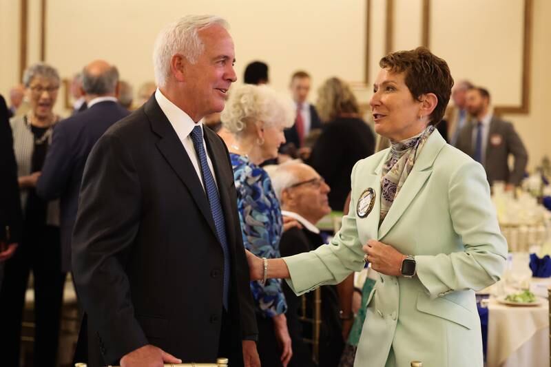 Joliet Mayor Terry D’Arcy and Gloria Dollinger, of the Joliet Rotary Club, converse at a luncheon to celebrate the 110th anniversary of the Rotary Club at Jacob Henry Mansion on Tuesday, Aug. 1 in Joliet.